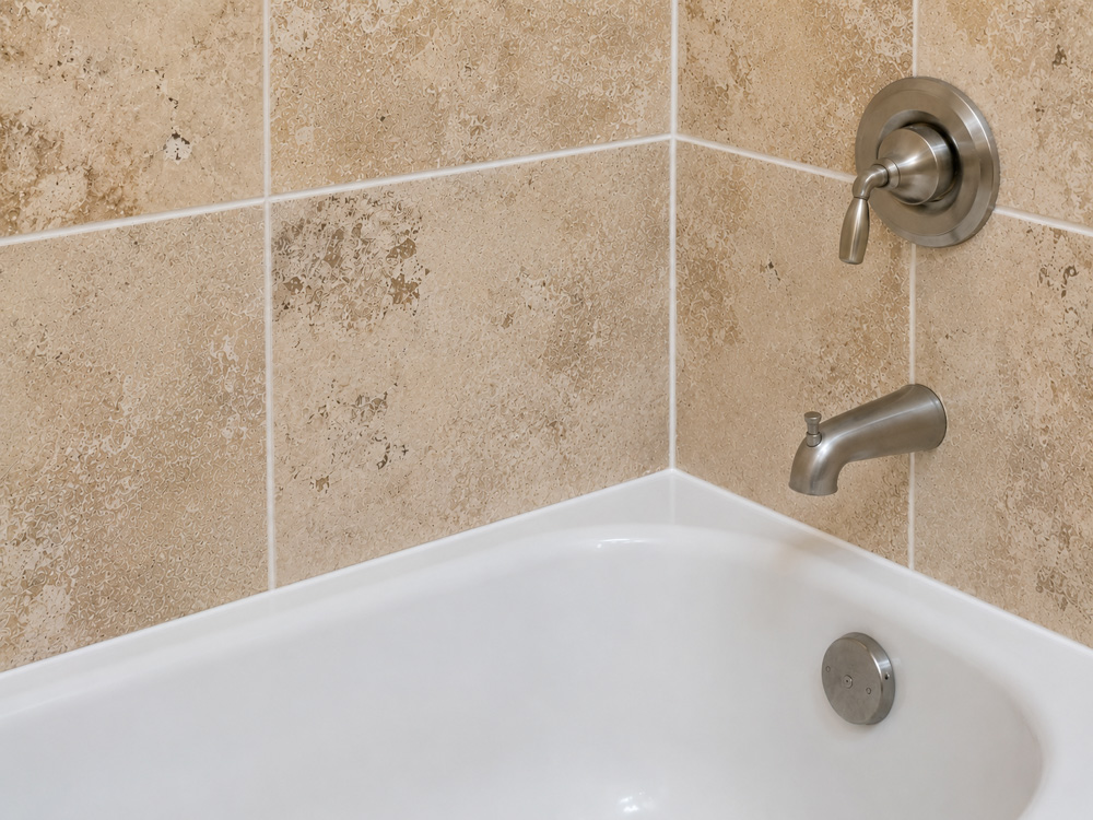 Clean, color-matched shower caulk after professional recaulking